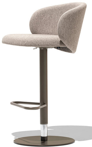 A modern bar stool with a curved upholstered seat and backrest in a light beige textured fabric, supported by a dark brown metal pedestal with a circular base and footrest, shown on a white background with a soft shadow.