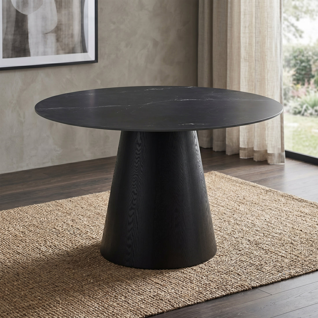 A modern round dining table with a dark black wood grain top and a tapered conical pedestal base, shown against a plain white background.