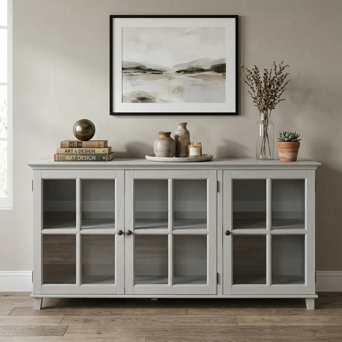 A light gray three-door sideboard cabinet with glass-paneled doors and open shelves, shown against a plain white background.