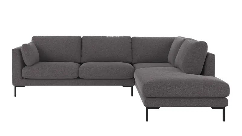 A modern three-seater sofa with a right-facing chaise lounge, upholstered in a textured red fabric, supported by slim black metal legs, shown against a plain white background.