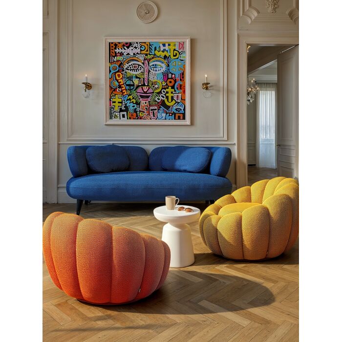 An orange textured pouf chair with a segmented, pumpkin-like design, shown against a plain white background.