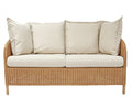 Wicker outdoor sofa with beige cushions on a white background