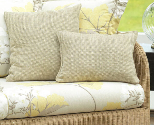 Wicker outdoor sofa with beige cushions on a white background