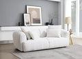 White sofa in a modern living room with gray walls and decorative elements.