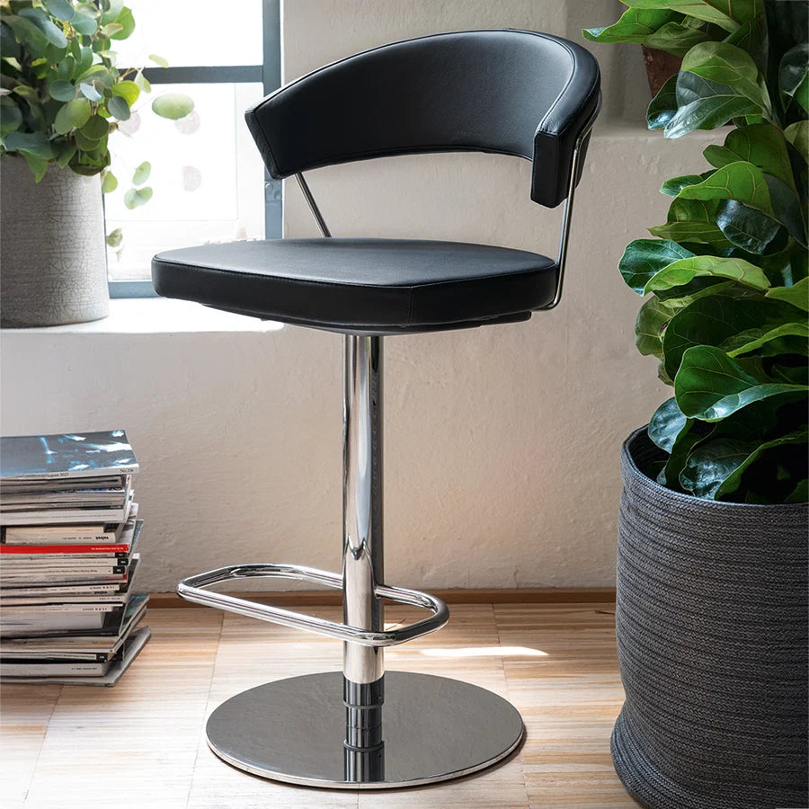Modern bar stool with brown seat and black base on a white background