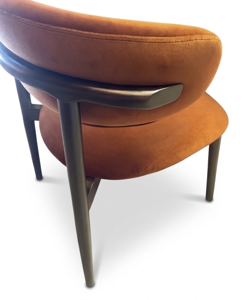 Brown cushioned chair with metal armrest on a white background