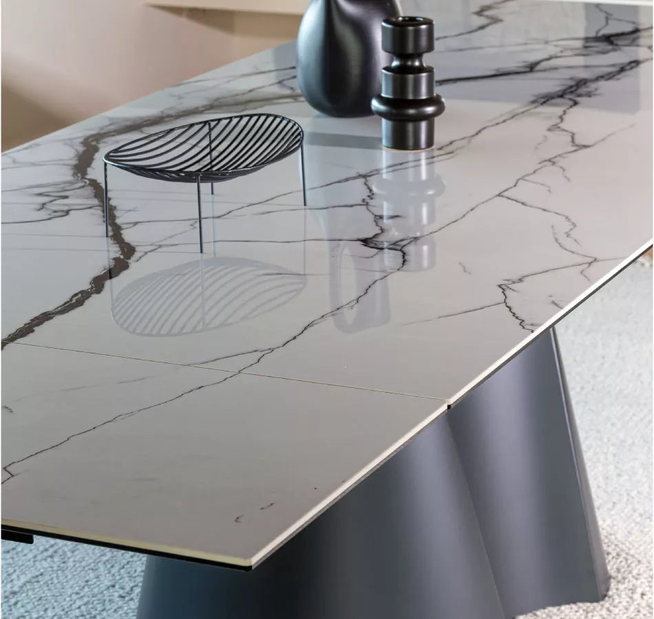 Dining table with marble top and black base on a white background