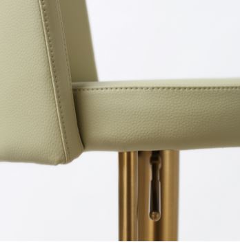 Bar stool with green seat and gold metal frame on a white background