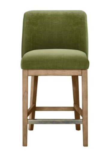 An upholstered bar stool with a green fabric seat and backrest, supported by a natural wood frame with a metal footrest.