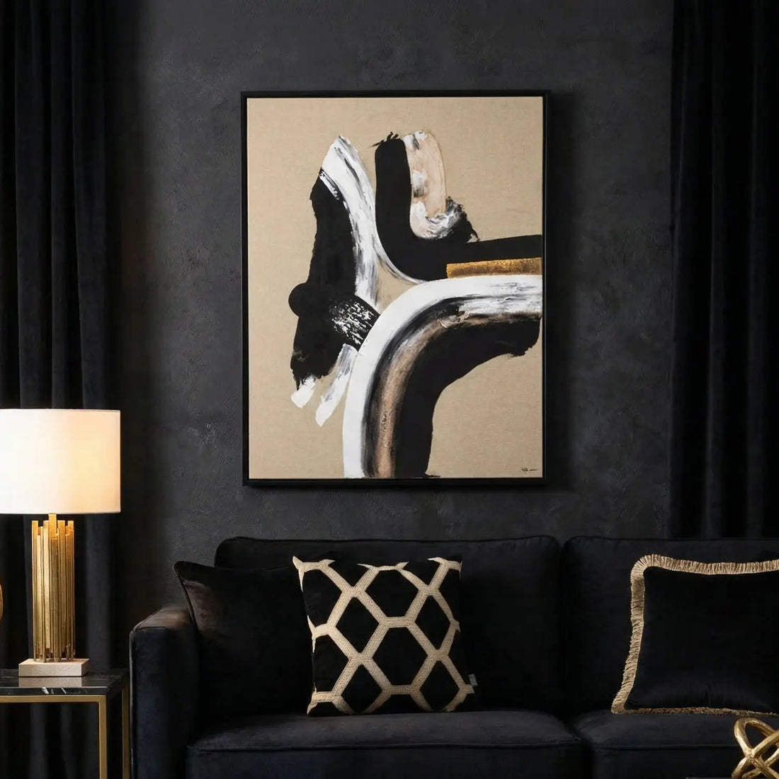 Abstract art piece with black, white, and gold on a beige background