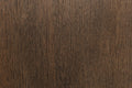 Close-up of a wooden surface with a dark brown color and visible grain pattern.