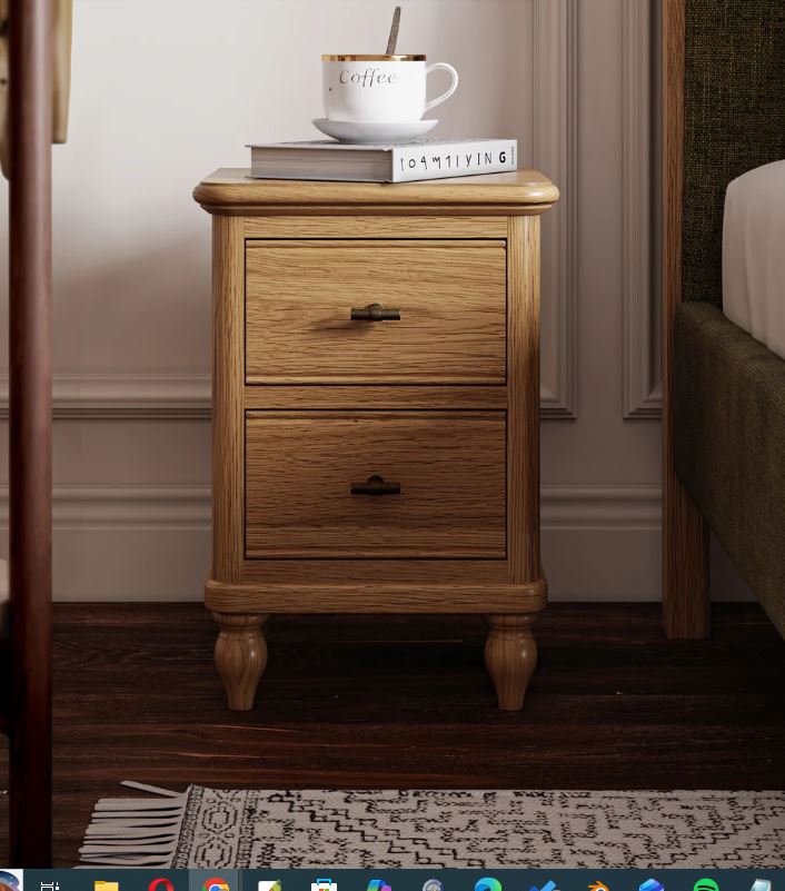 Wooden nightstand with two drawers, a mug, and books in a bedroom setting.