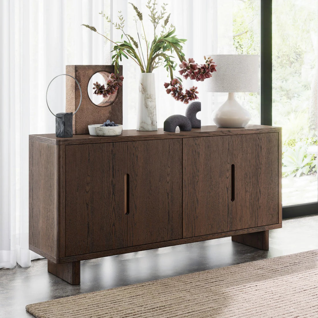 Dark wood cabinet with four doors on a white background