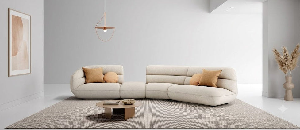 Modern living room with a beige sectional sofa, coffee table, and decorative elements.slider_item_tMdbGe