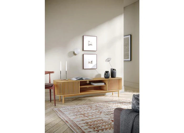 Wooden TV stand with slatted design on a white background