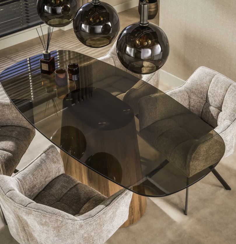 Round dining table with a glass top and wooden base on a white background