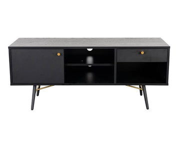 A modern black media console with a textured gray top, two cabinet doors with brass knobs, an open center shelf, and tapered black legs with brass accents, shown against a plain white background.