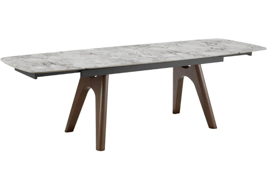 Dining table with marble-like top and wooden legs on a white background